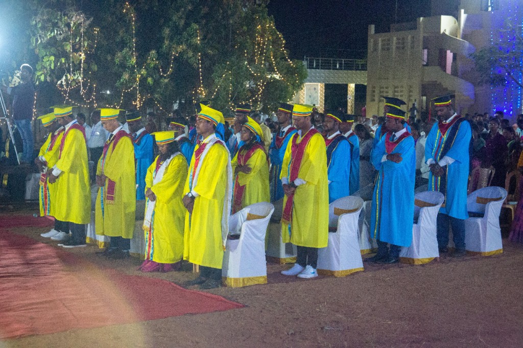 Graduation - Graduates in academic regalia at evening ceremony